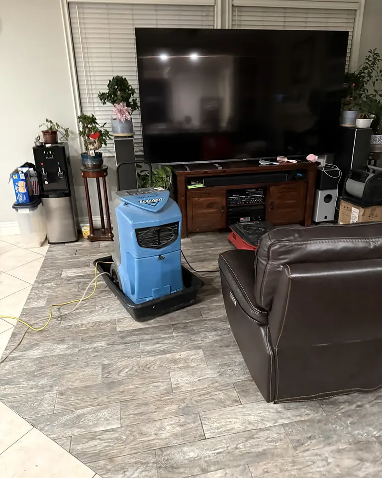 Structural drying equipment in a living room after water damage