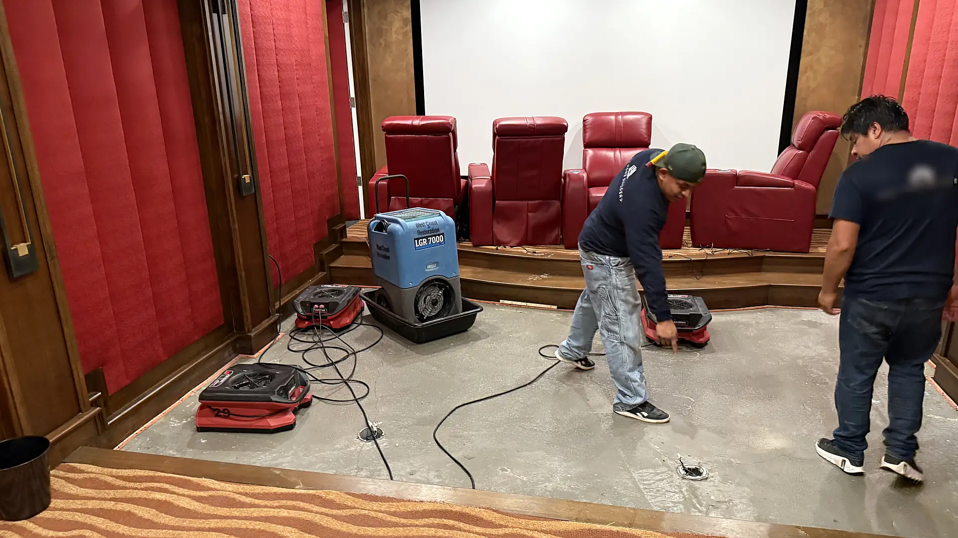 Flood-Pro team drying a water-damaged home theater in Newport Coast, Newport Beach