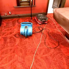 Carpet drying with an air mover next to a pool table