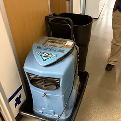 Commercial dehumidifier drying a hallway after a leak
