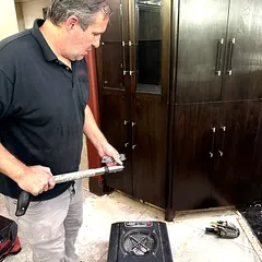 Technician removing water-damaged flooring