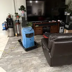 Structural drying equipment in a living room after water damage