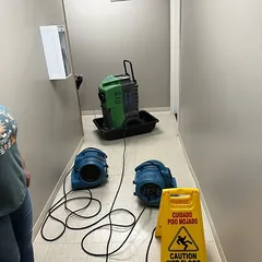 Air movers and wet floor sign during office flood cleanup